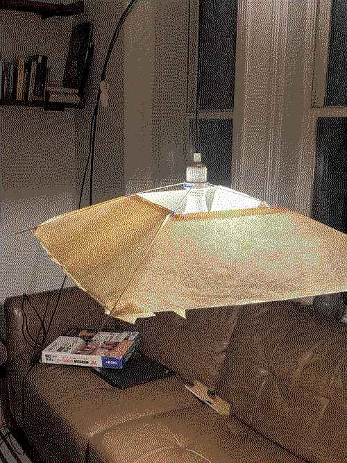 a paper lampshade made with wires and four rice paper panels.