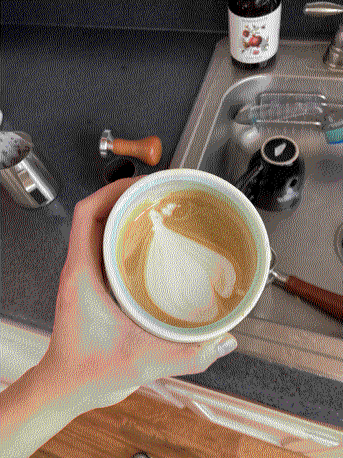 an overhead shot of a latte, with the latte art looking like a garlic.