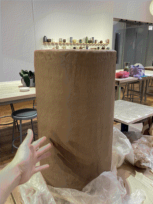 a tall brown clay cylinder