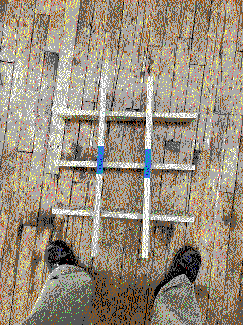 a wooden grid shelf on the floor